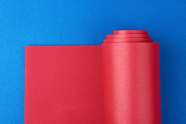 neoprene red twisted mat lies on a blue mat, sports equipment, copy space